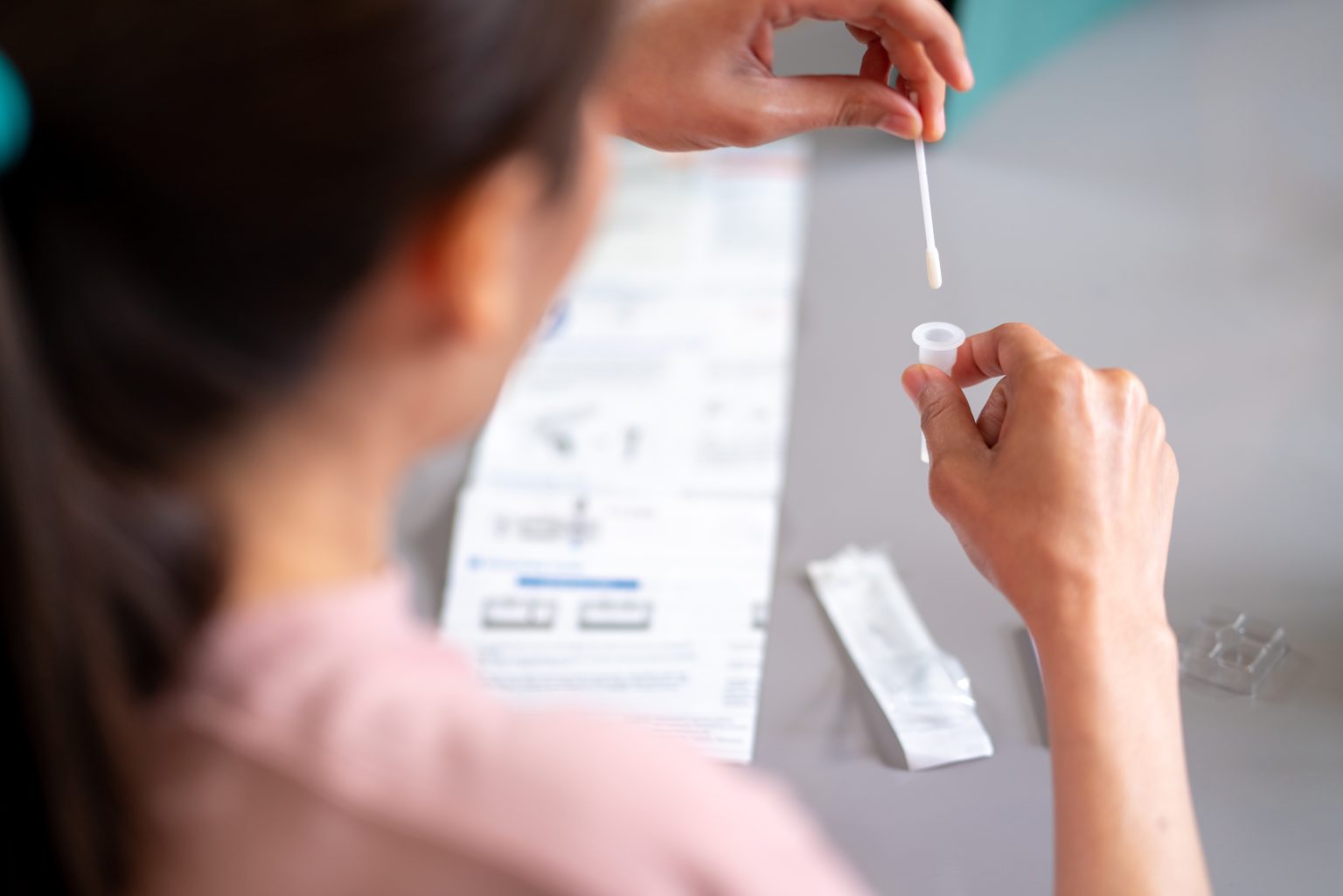 At-Home Molecular Diagnostics Moves Into Cervical Cancer Screening — The Syrona Health Strategy Woman preparing an at-home HPV self-sampling kit for laboratory-based cervical cancer screening.